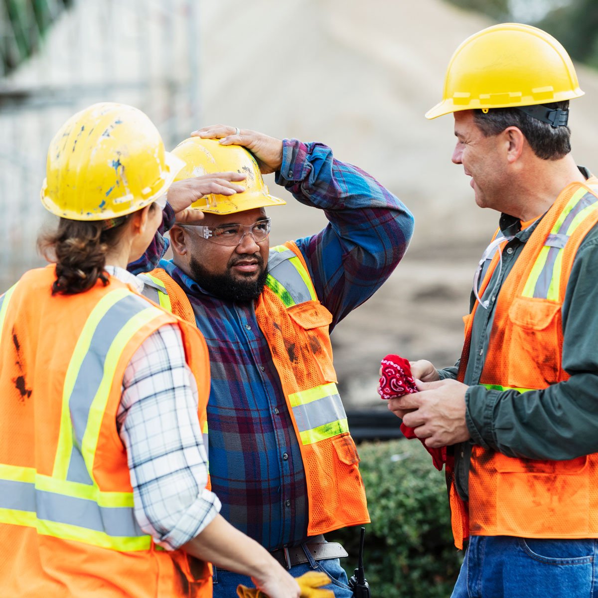 three construction workers chatting