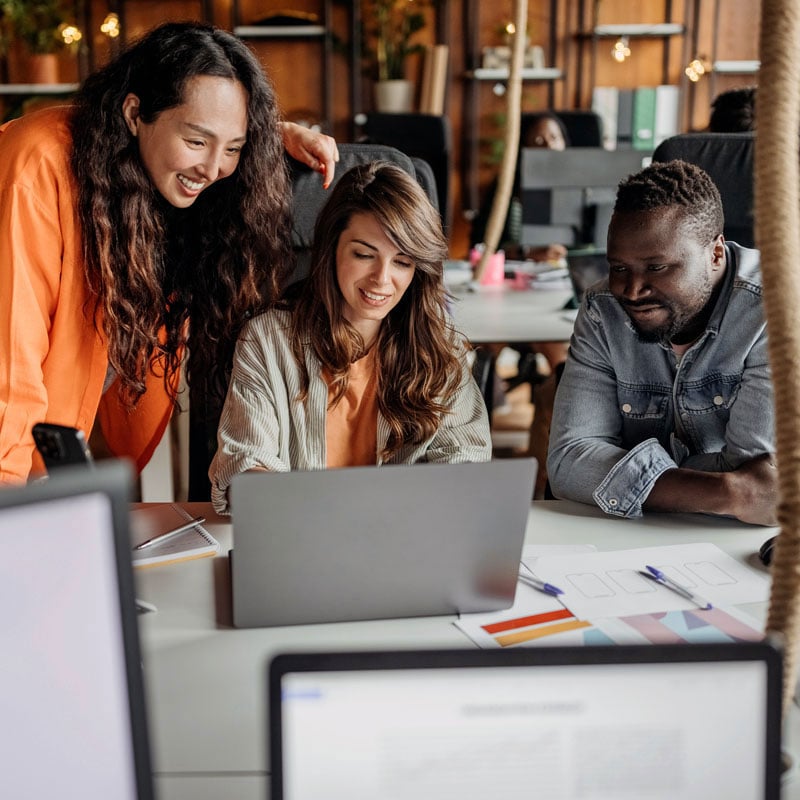 three office employees on laptop