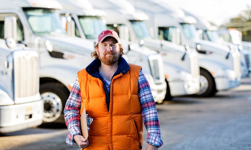 truck driver in front of trucks
