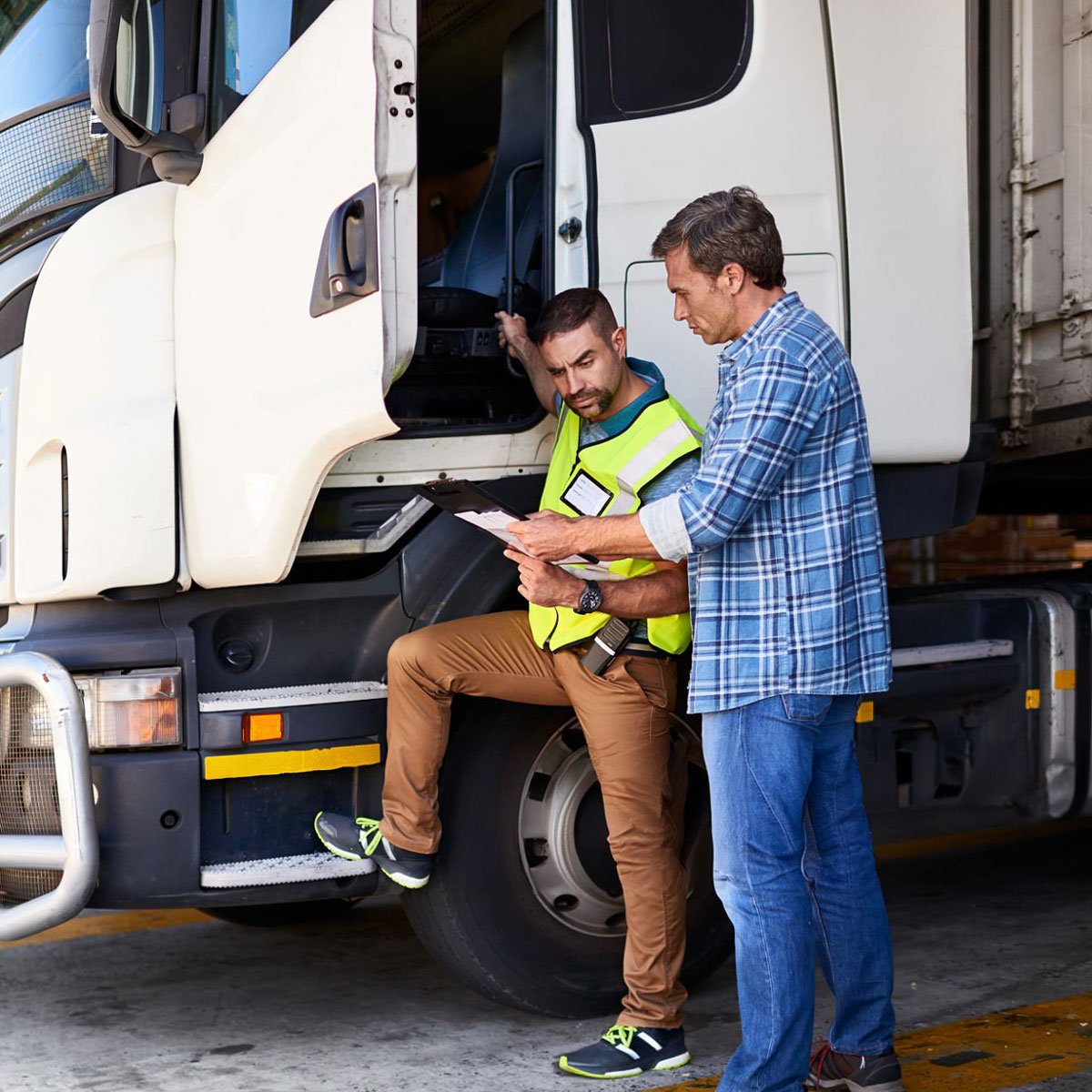 trucking employees chatting outside truck