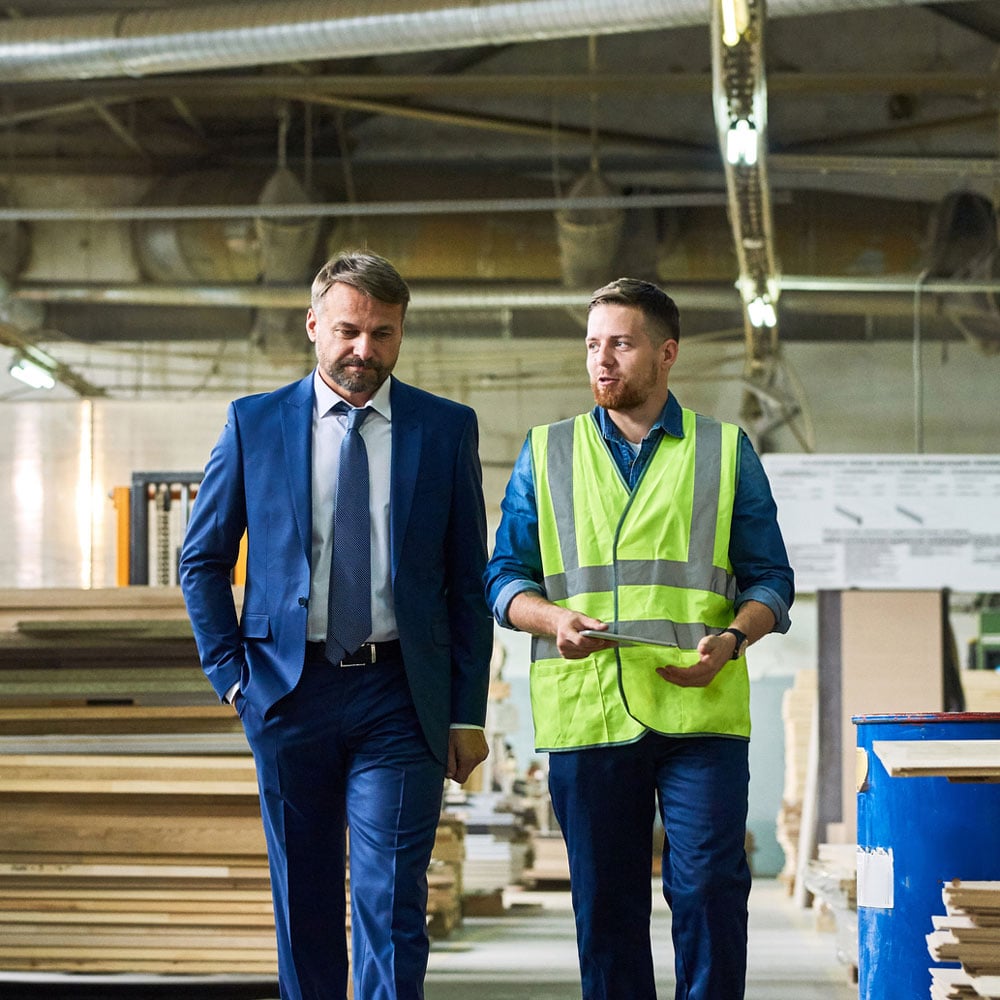 Two Employees Walking In Factory