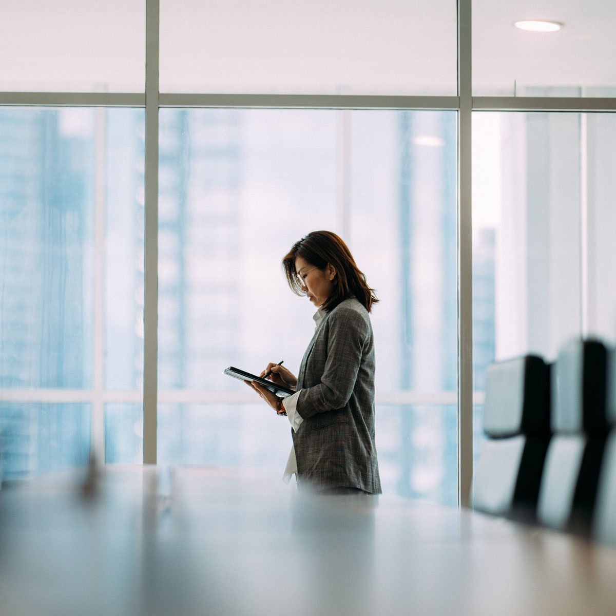 woman in conference room on tablet